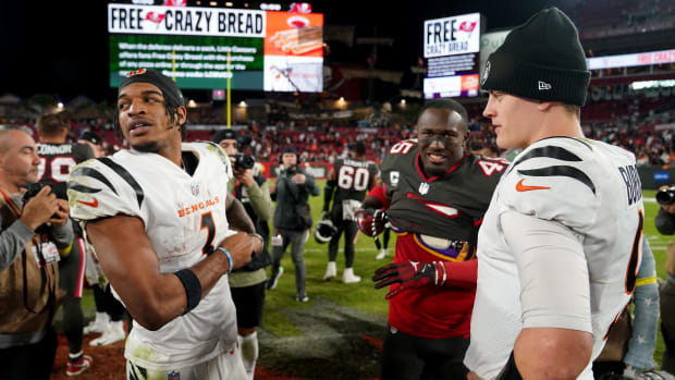 Cincinnati Bengals quarterback Joe Burrow (9) and Cincinnati Bengals wide receiver Ja'Marr Chase (1) talk with Tampa Bay Buccaneers linebacker Devin White (45) at the conclusion of a Week 15 NFL game, Sunday, Dec. 18, 2022, at Raymond James Stadium in Tampa, Fla. The Cincinnati Bengals won, 34-23. The Cincinnati Bengals improved to 10-4 on the season. Nfl Cincinnati Bengals At Tampa Bay Buccaneers Dec 18 0424